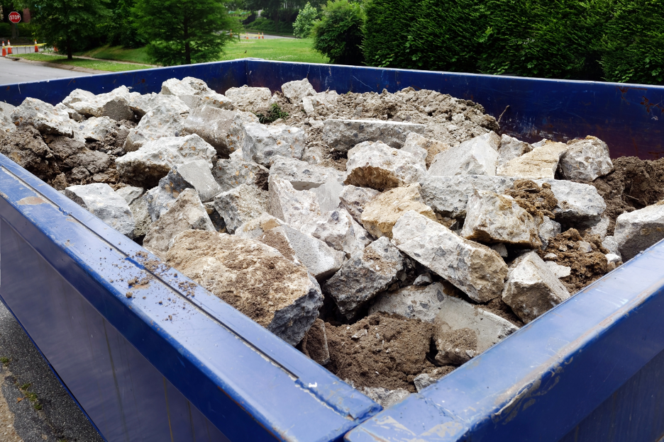 Rental dumpster filled with rocks at a house in Elm Grove, Wisconsin